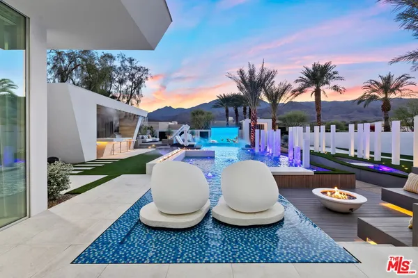 a dining room with wooden floor and large windows