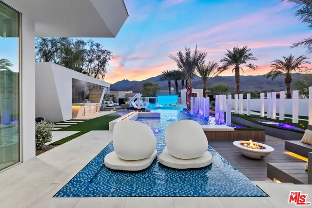 a dining room with wooden floor and large windows