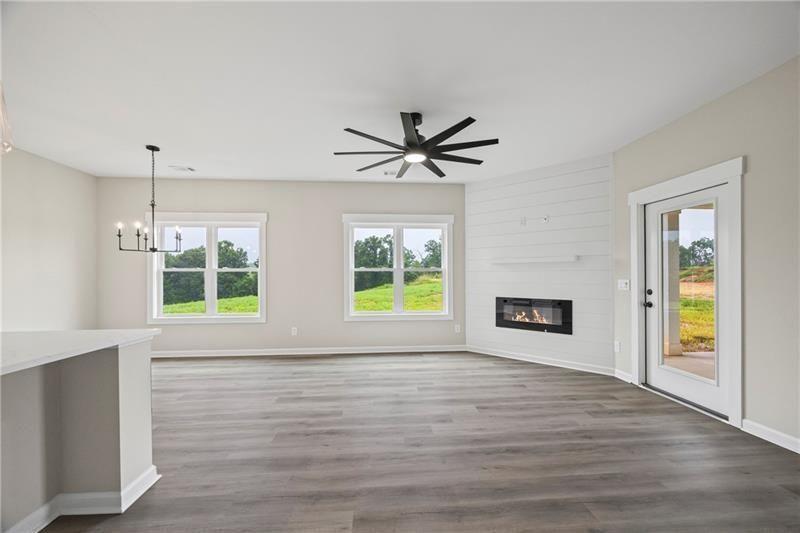 693 Racetrack Road Toccoa, GA 30577 - Photo 9 of 45 a view of an empty room with wooden floor and a window