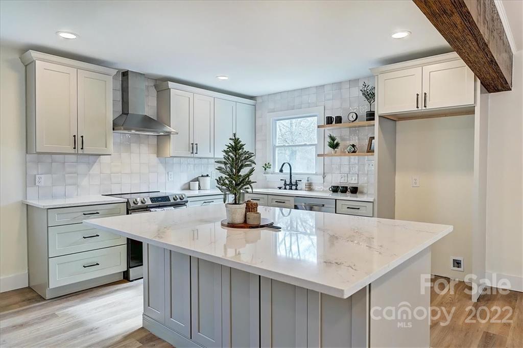 1085 Donnybrook Road Catawba, SC 29704 - Photo 3 of 32 a kitchen with granite countertop a sink a stove a refrigerator and white cabinets