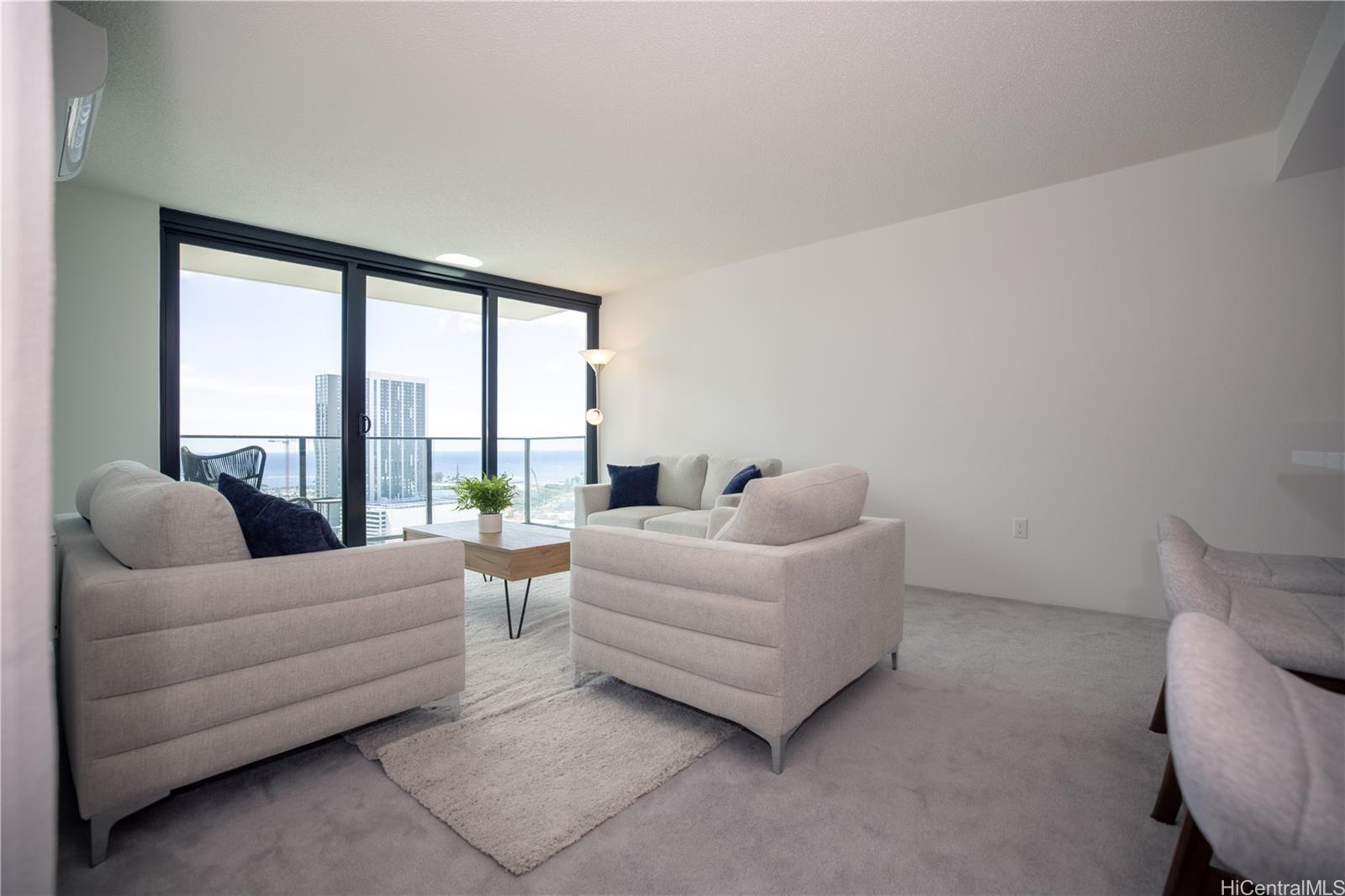 615 Keawe Street, Unit 2408 Honolulu, HI 96813 - Photo 4 of 5 a living room with furniture and a large window