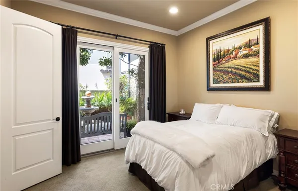 a bedroom with a bed and large glass window