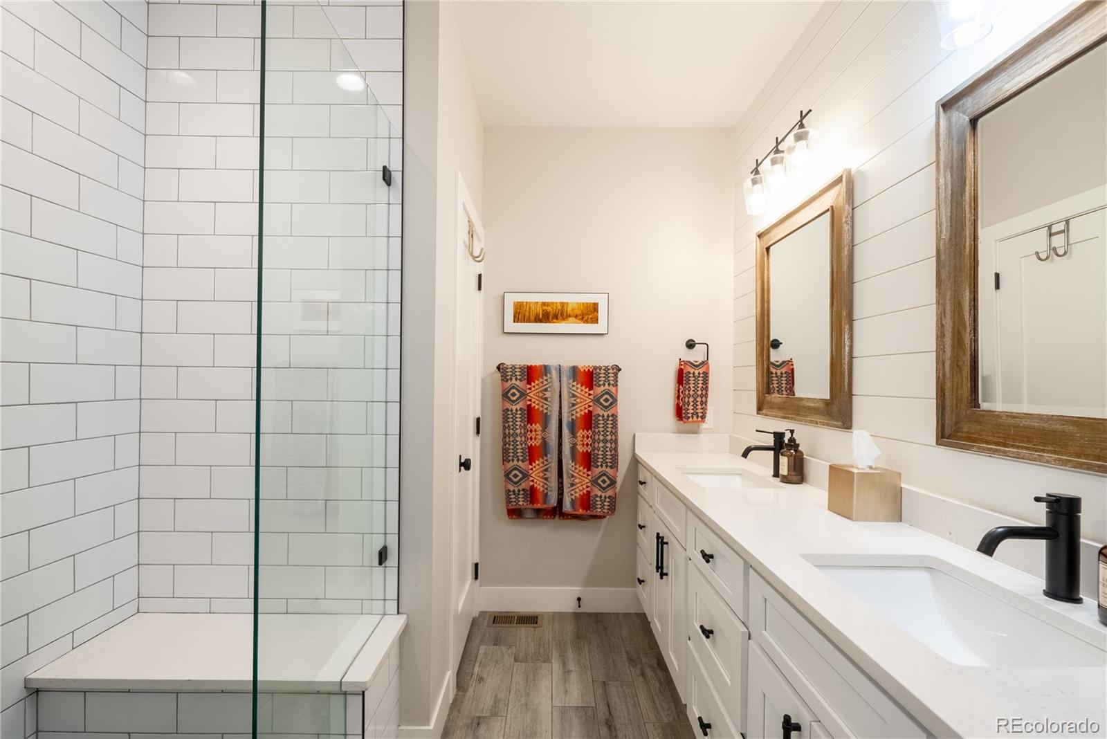 4035 Osage Street Denver, CO 80211 - Photo 13 of 29 a spacious bathroom with a double vanity sink a large mirror and a shower