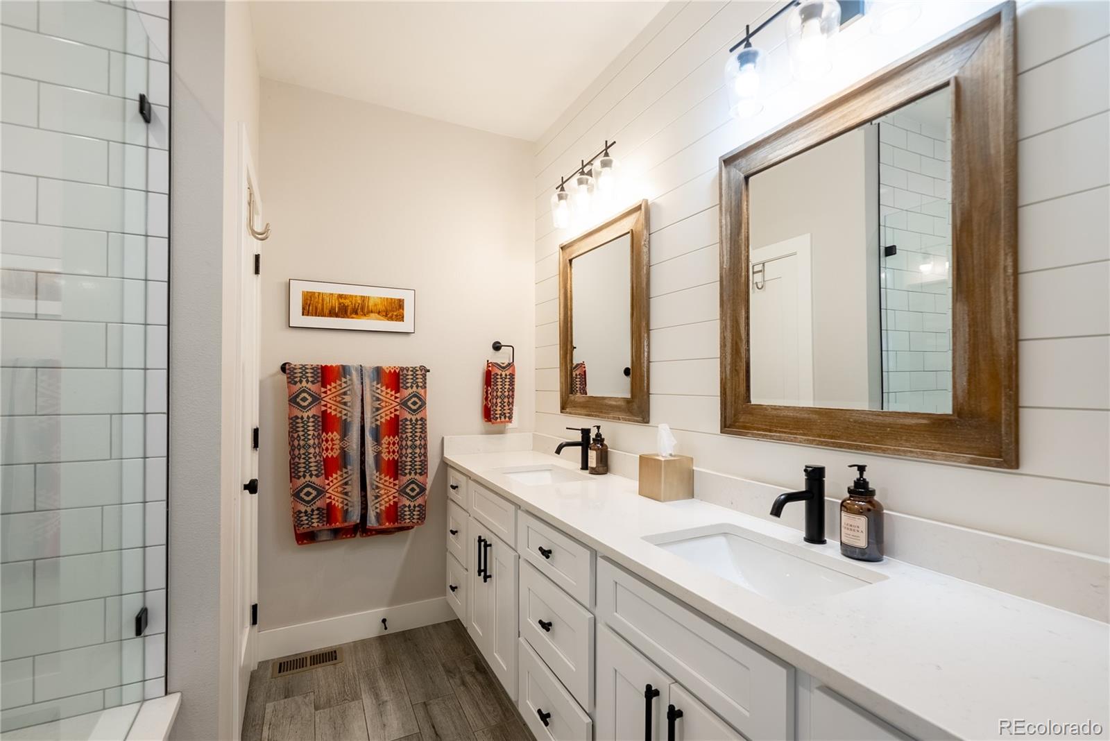 4035 Osage Street Denver, CO 80211 - Photo 14 of 29 a bathroom with a double vanity sink and a mirror