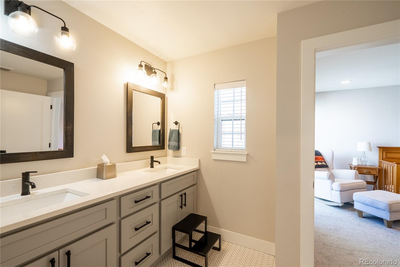4035 Osage Street Denver, CO 80211 - Photo 20 of 29 a en suite bathroom with a double vanity sink and a mirror