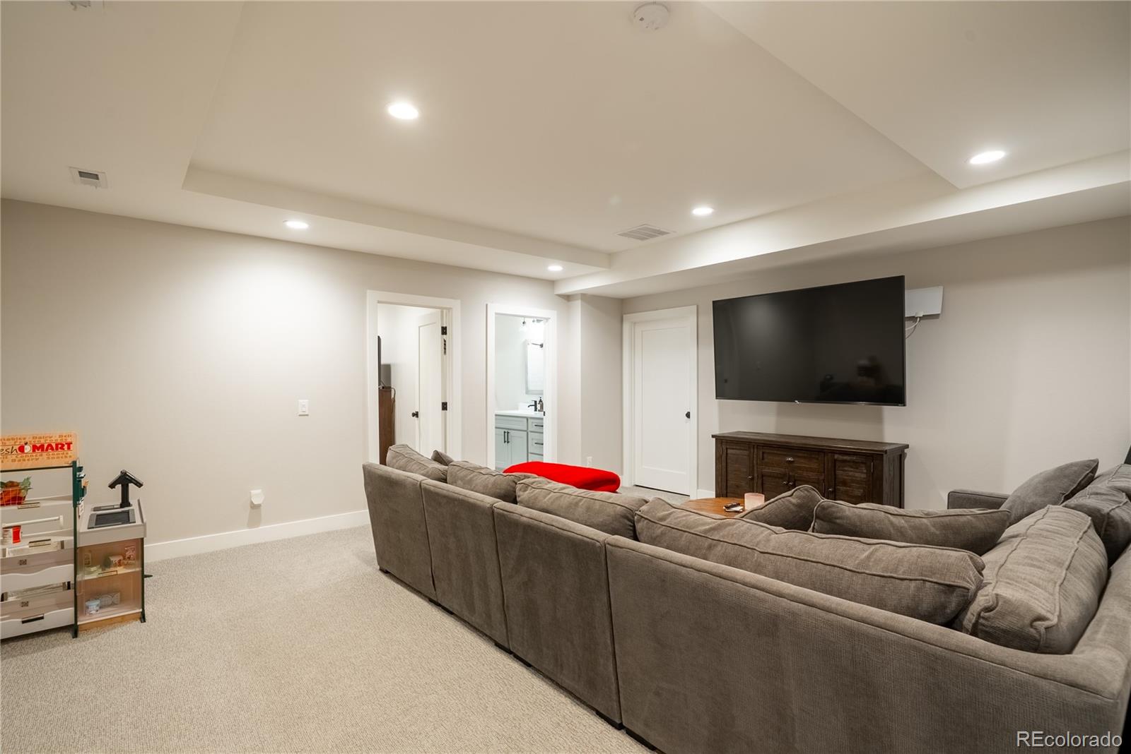4035 Osage Street Denver, CO 80211 - Photo 21 of 29 a living room with furniture and a flat screen tv