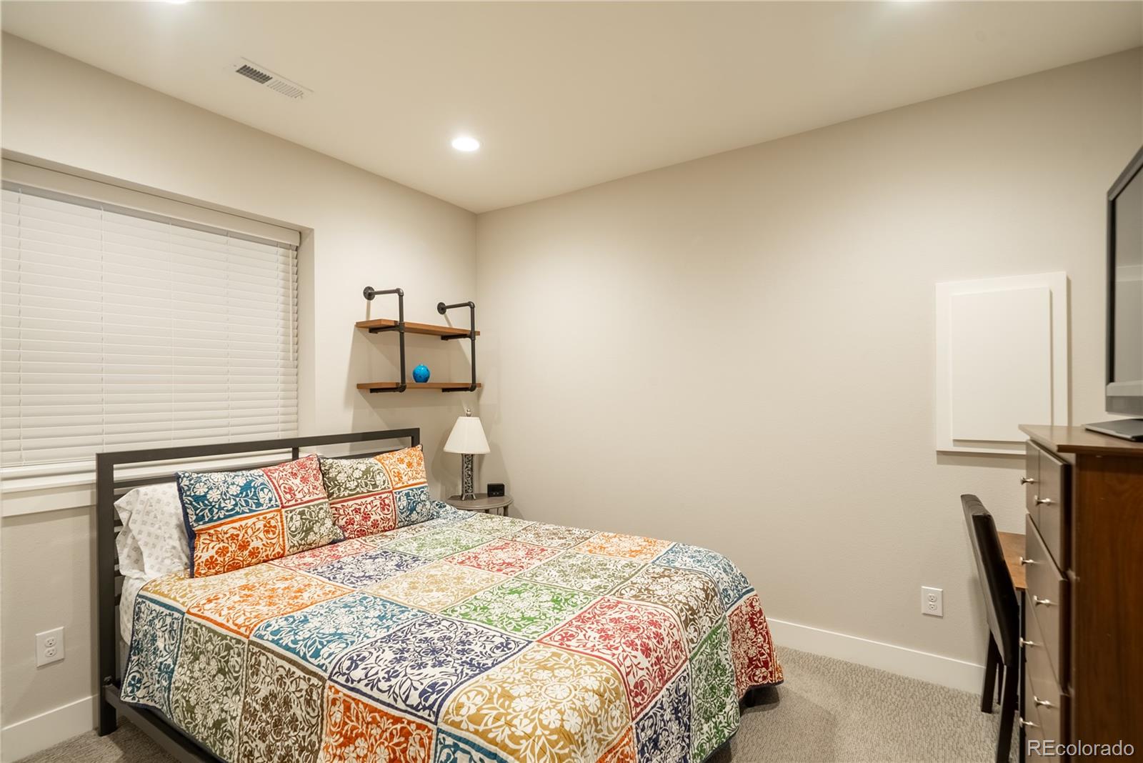 4035 Osage Street Denver, CO 80211 - Photo 23 of 29 a bedroom with a bed and a chair