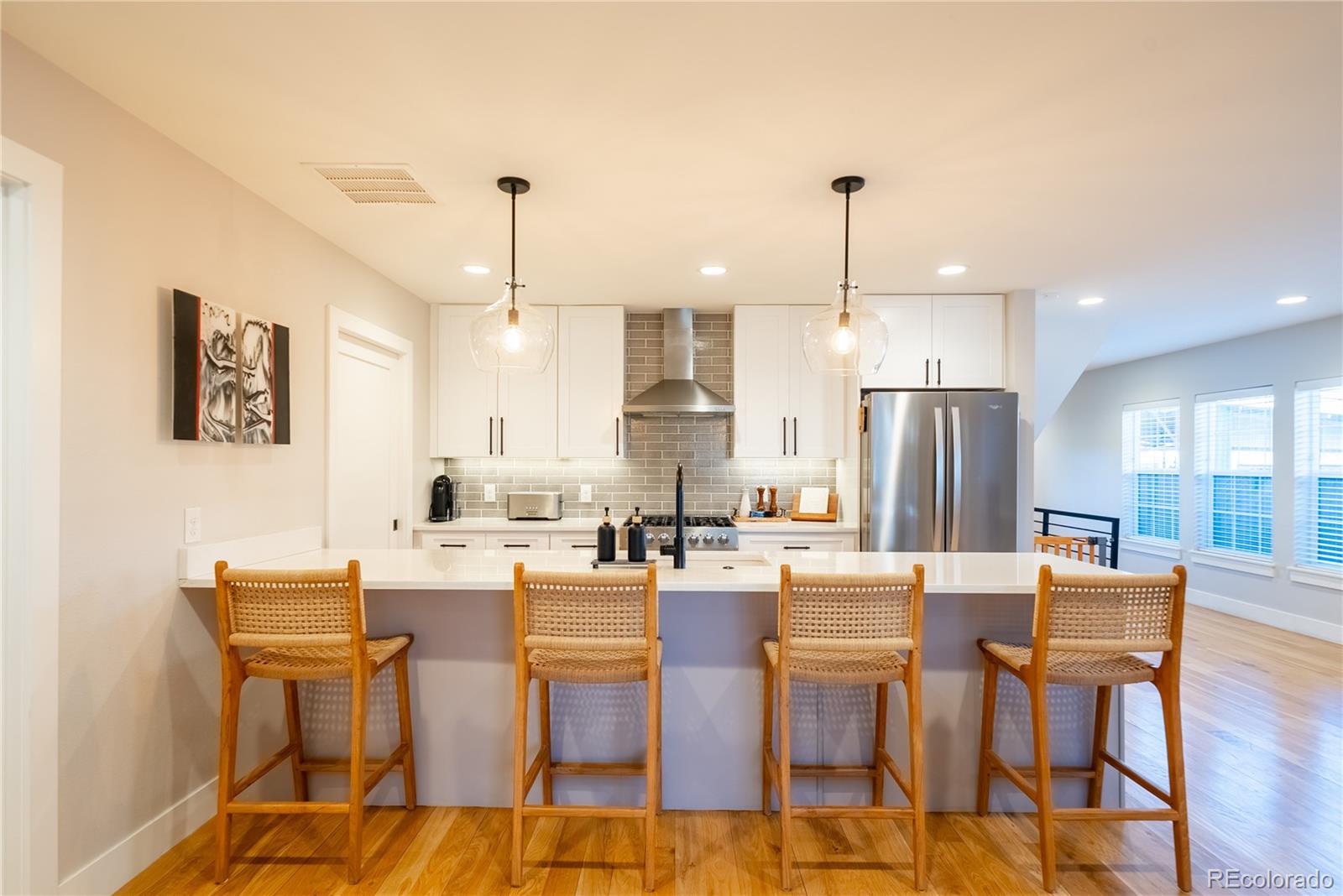 4035 Osage Street Denver, CO 80211 - Photo 6 of 29 a dining hall with stainless steel appliances kitchen island granite countertop a dining table chairs and a refrigerator