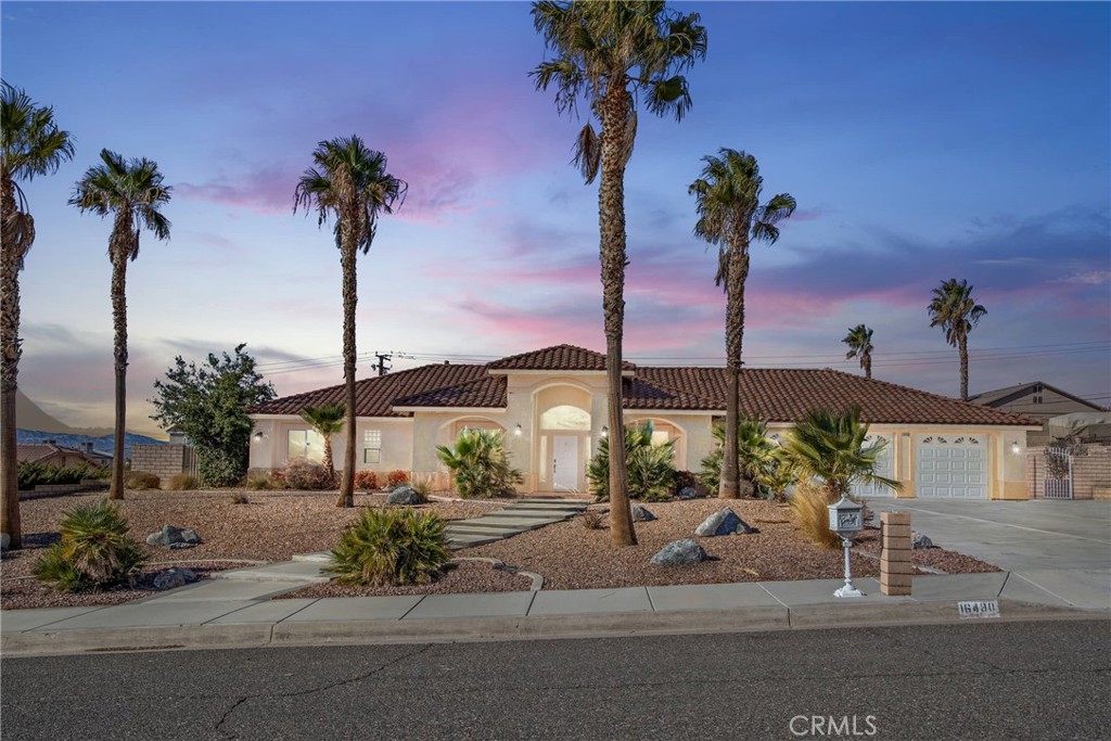 16490 Quantico Road Apple Valley, CA 92307 - Photo 1 of 1 a front view of a house with a garden