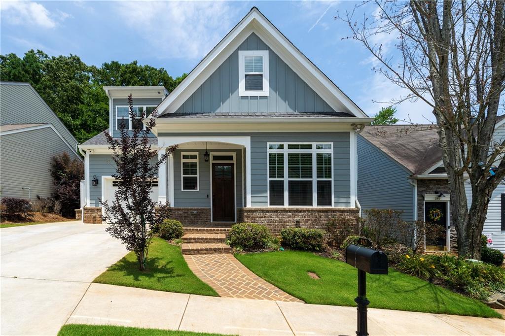 a front view of a house with a yard and porch