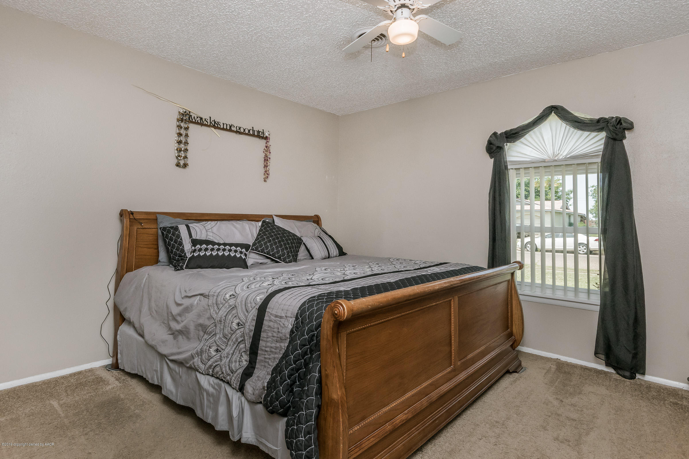 5145 McCarty Boulevard Amarillo, TX 79110 - Photo 11 of 21 a bedroom with a bed and a window