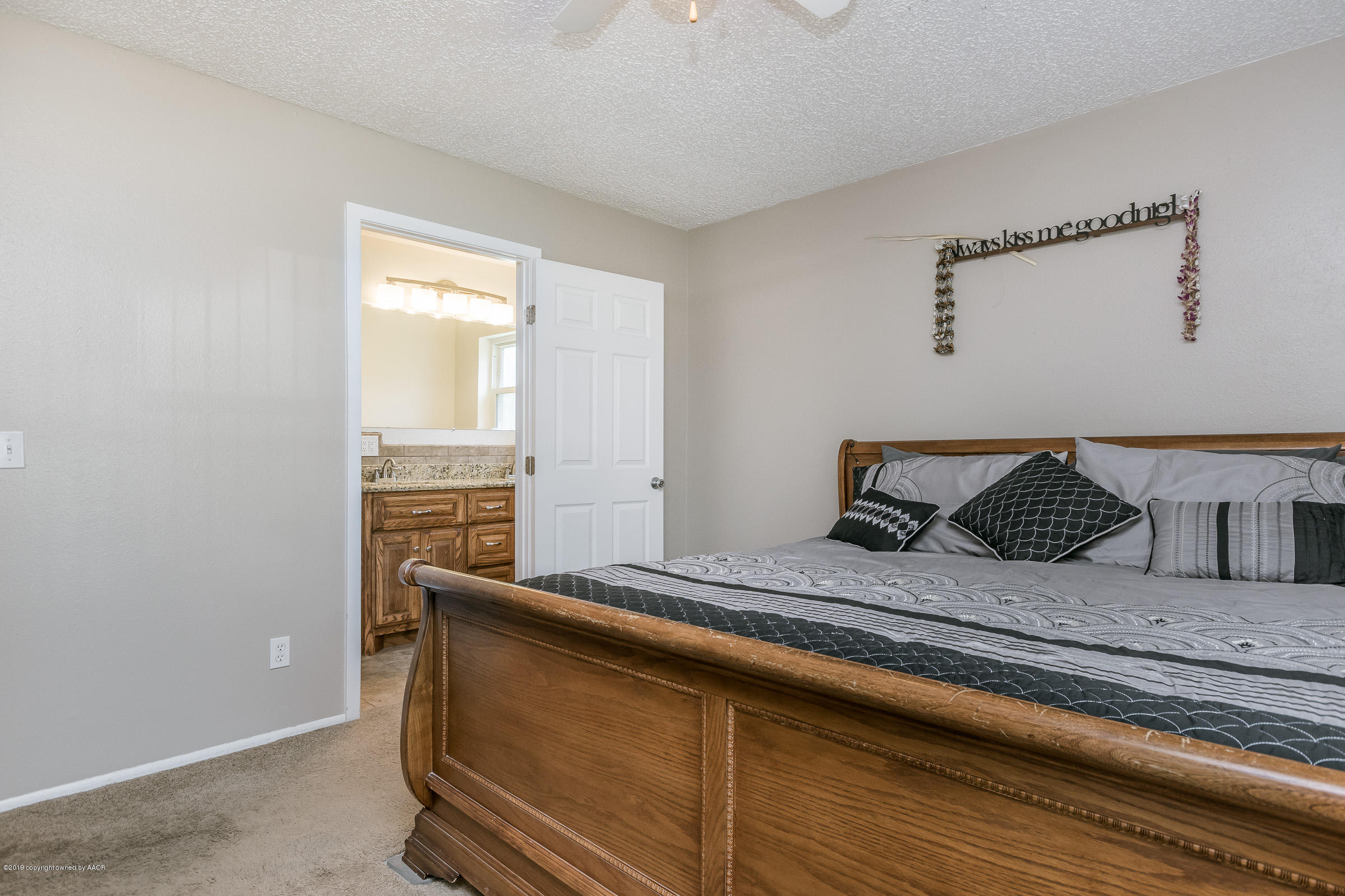 5145 McCarty Boulevard Amarillo, TX 79110 - Photo 12 of 21 a bedroom with a bed and a window