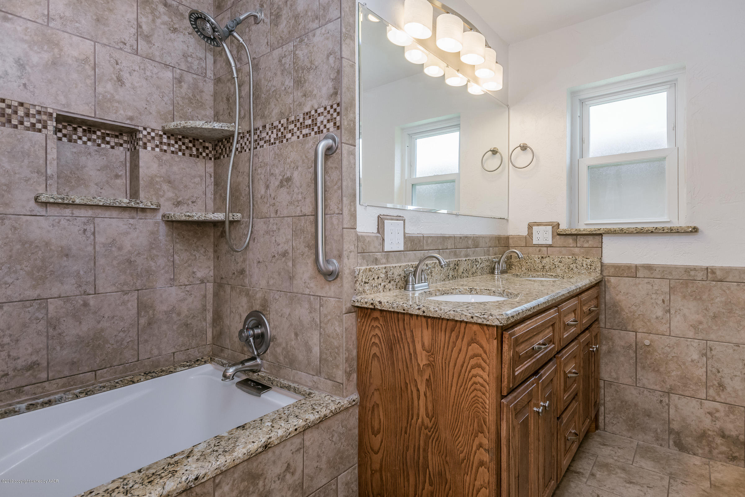 5145 McCarty Boulevard Amarillo, TX 79110 - Photo 13 of 21 a bathroom with a granite countertop sink a mirror and a bathtub