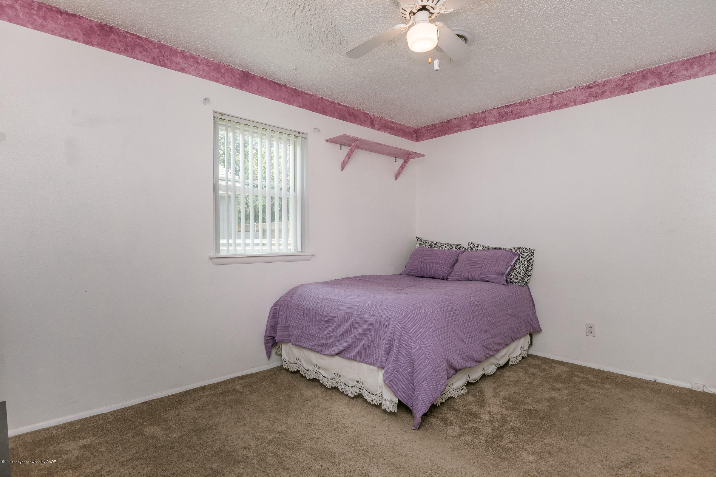 5145 McCarty Boulevard Amarillo, TX 79110 - Photo 14 of 21 a spacious bedroom with a bed and a window