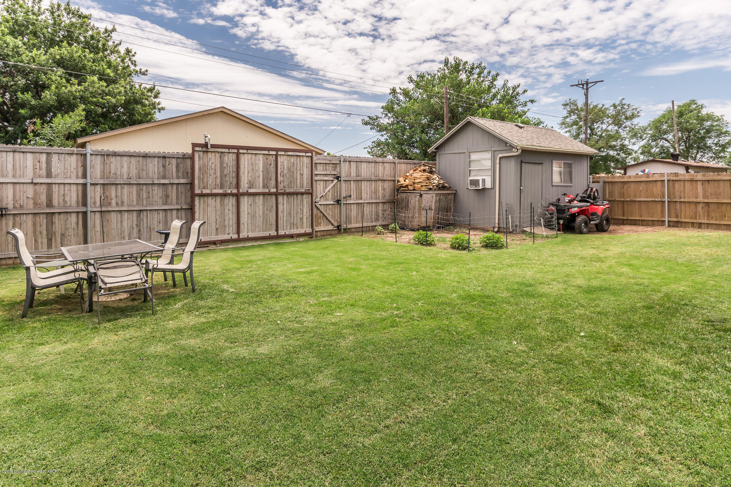 5145 McCarty Boulevard Amarillo, TX 79110 - Photo 19 of 21 a view of a backyard with table and chairs and wooden fence