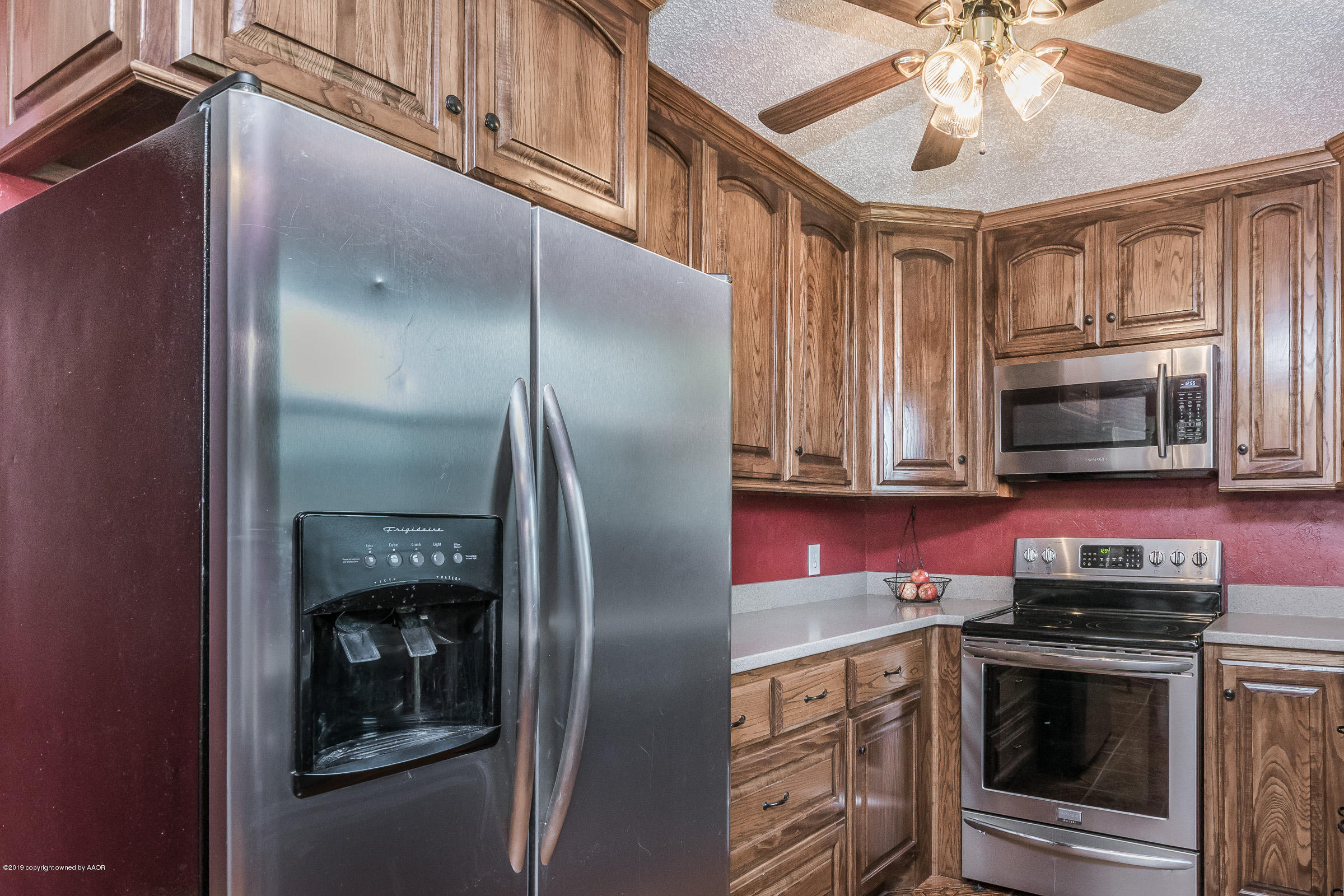 5145 McCarty Boulevard Amarillo, TX 79110 - Photo 8 of 21 a kitchen with stainless steel appliances granite countertop a refrigerator a stove and a microwave