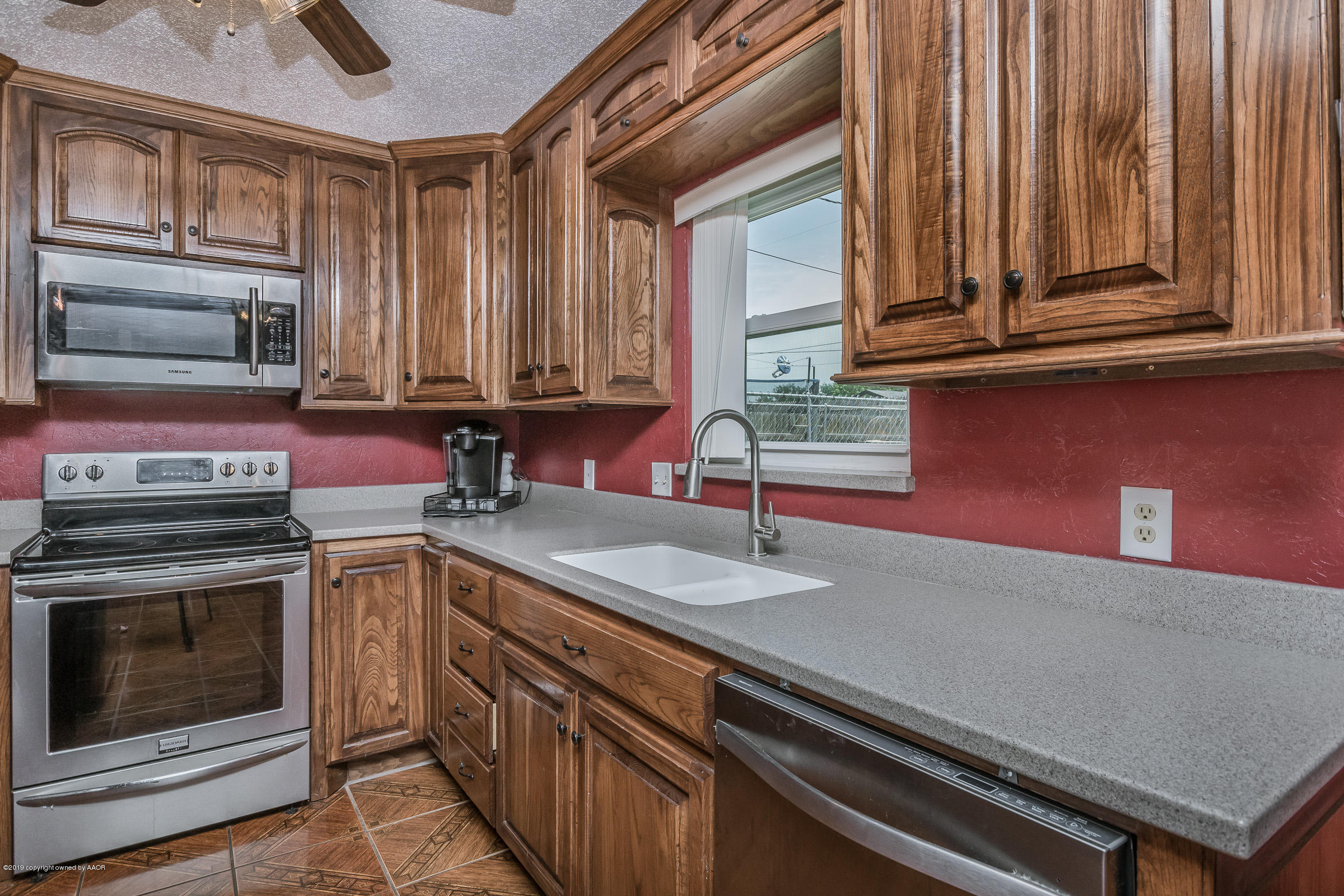 5145 McCarty Boulevard Amarillo, TX 79110 - Photo 9 of 21 a kitchen with granite countertop a stove sink and cabinets