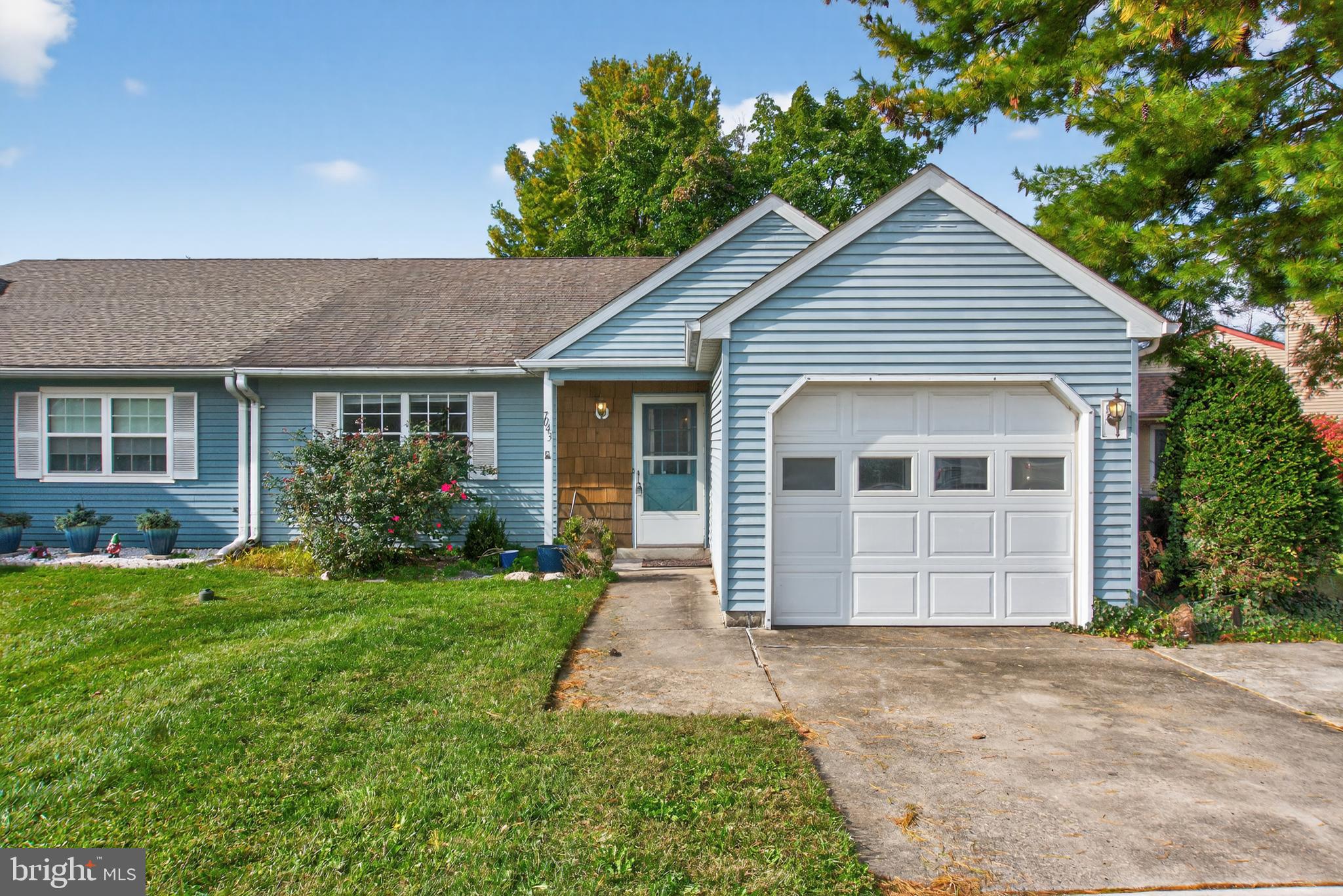 7043 Basswood Road Frederick, MD 21703 - Photo 1 of 34 a front view of a house with a garden