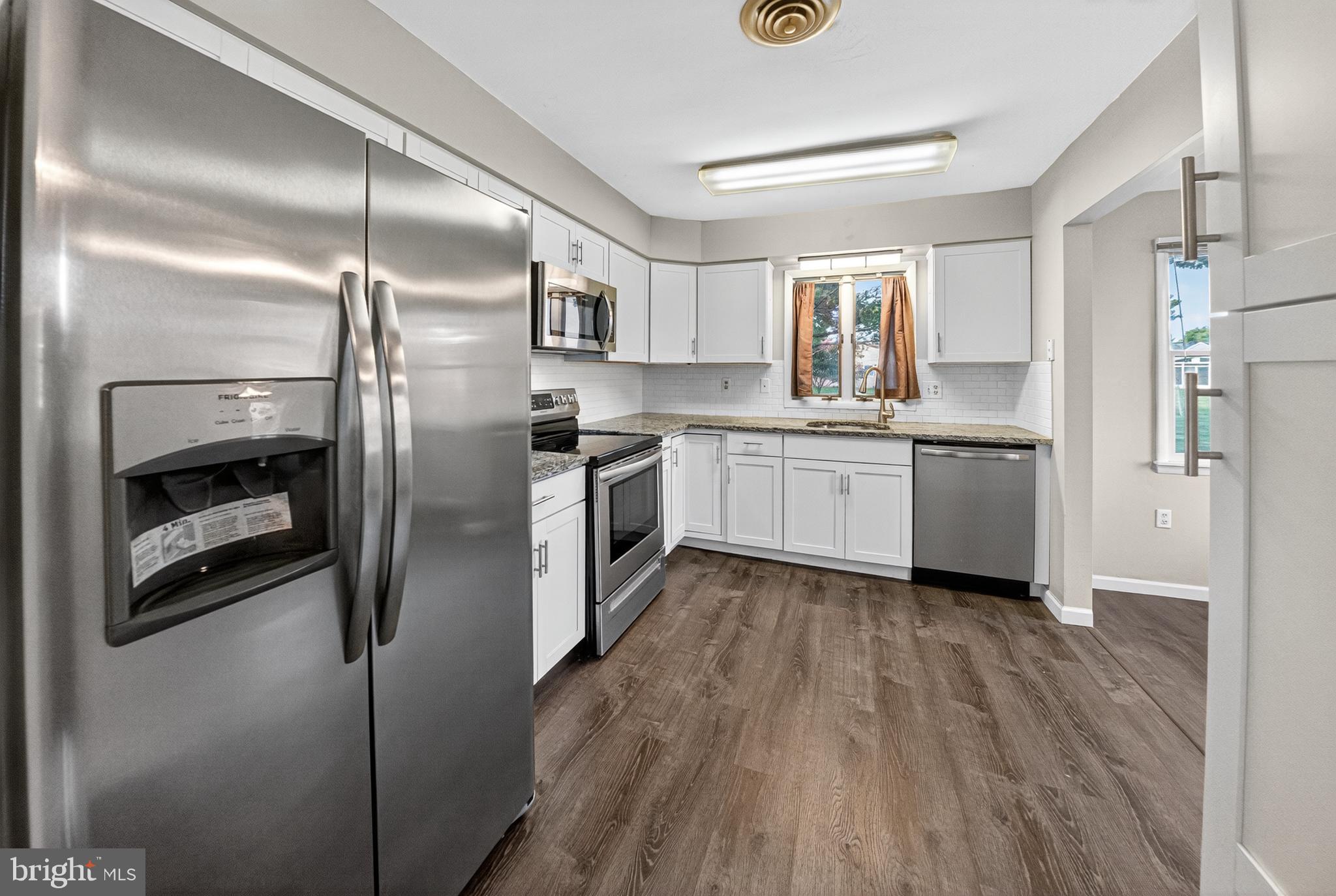 7043 Basswood Road Frederick, MD 21703 - Photo 11 of 34 a kitchen with stainless steel appliances granite countertop a refrigerator a stove and a sink