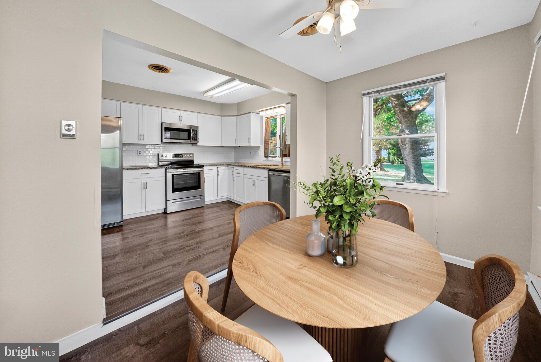 7043 Basswood Road Frederick, MD 21703 - Photo 12 of 34 a dining room with furniture and wooden floor