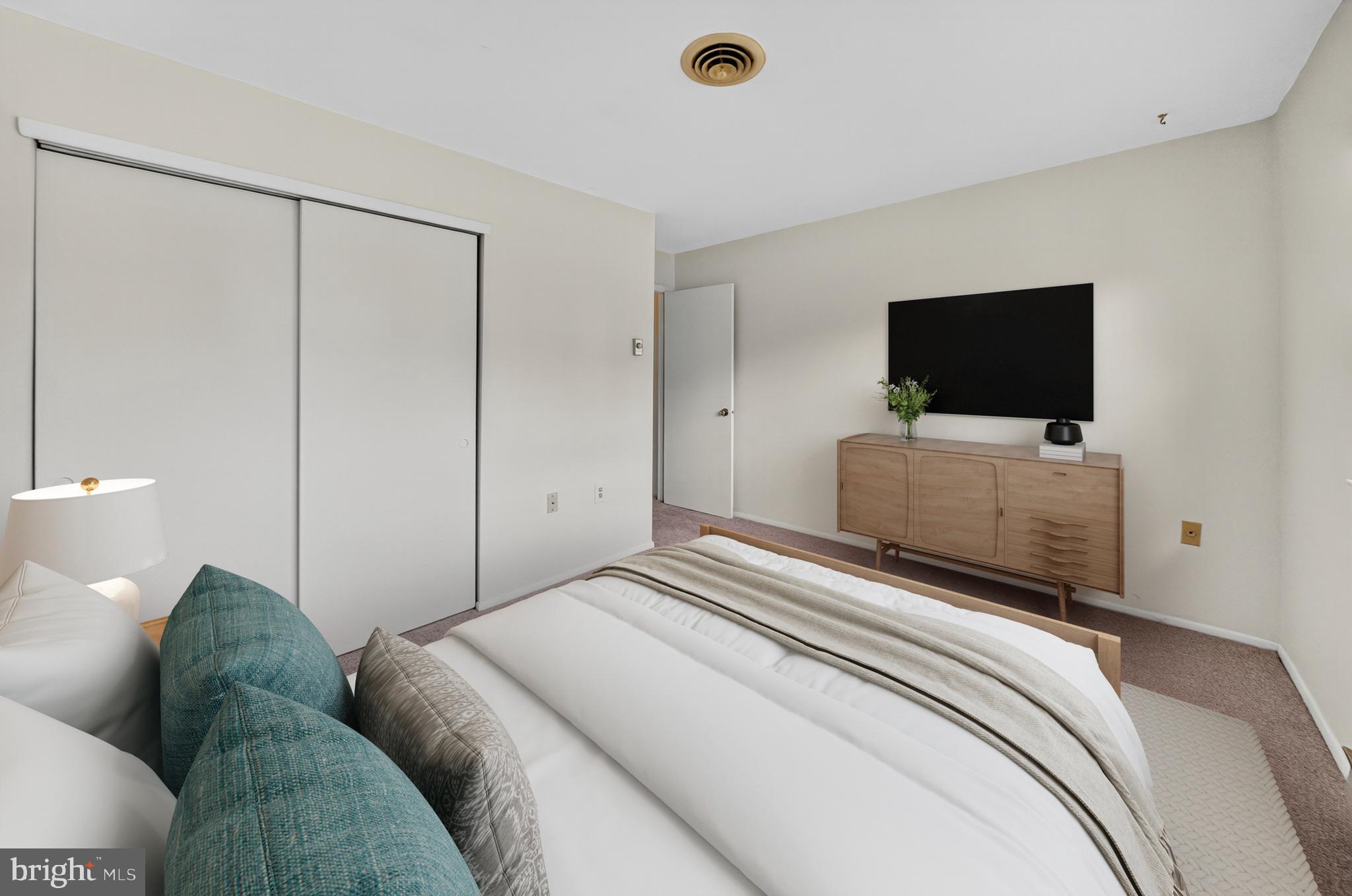 7043 Basswood Road Frederick, MD 21703 - Photo 18 of 34 a bedroom with a bed and a flat screen tv