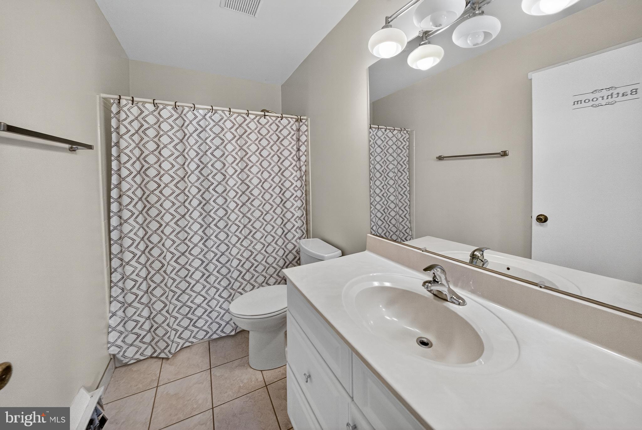 7043 Basswood Road Frederick, MD 21703 - Photo 19 of 34 a bathroom with a sink toilet and a mirror