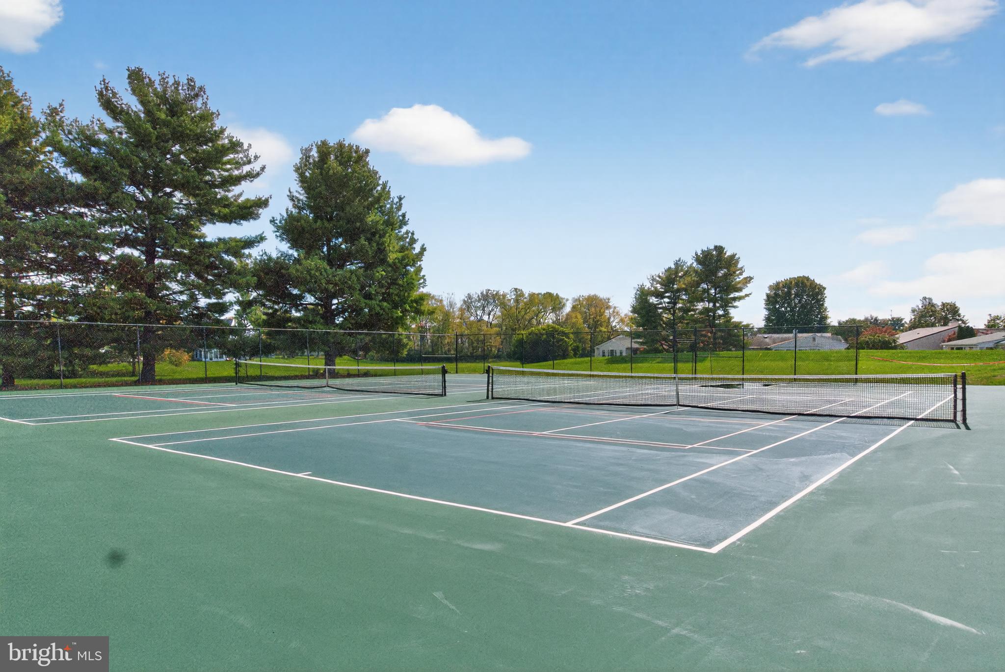 7043 Basswood Road Frederick, MD 21703 - Photo 28 of 34 a view of a tennis ground with large trees