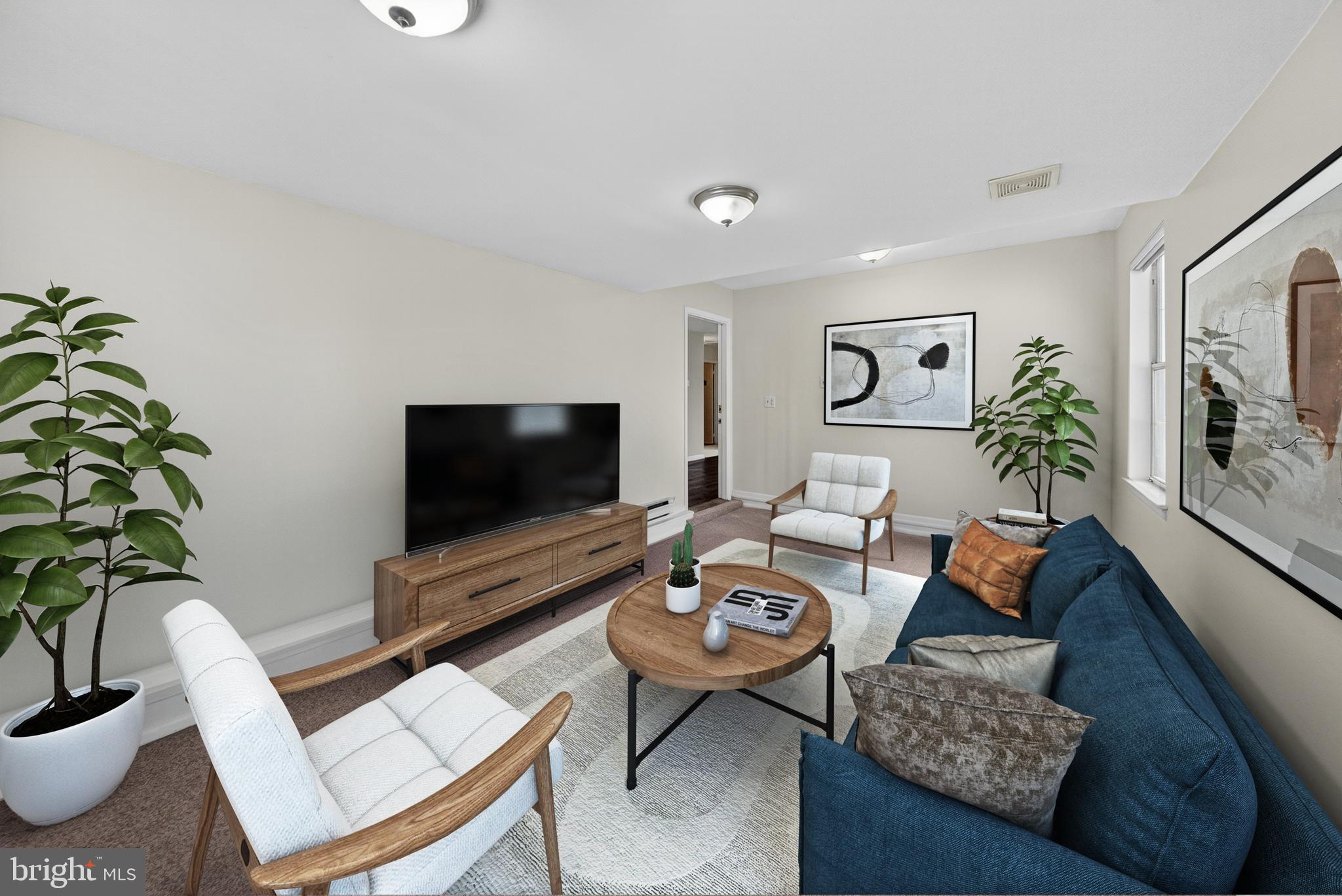 7043 Basswood Road Frederick, MD 21703 - Photo 5 of 34 a living room with furniture and a flat screen tv