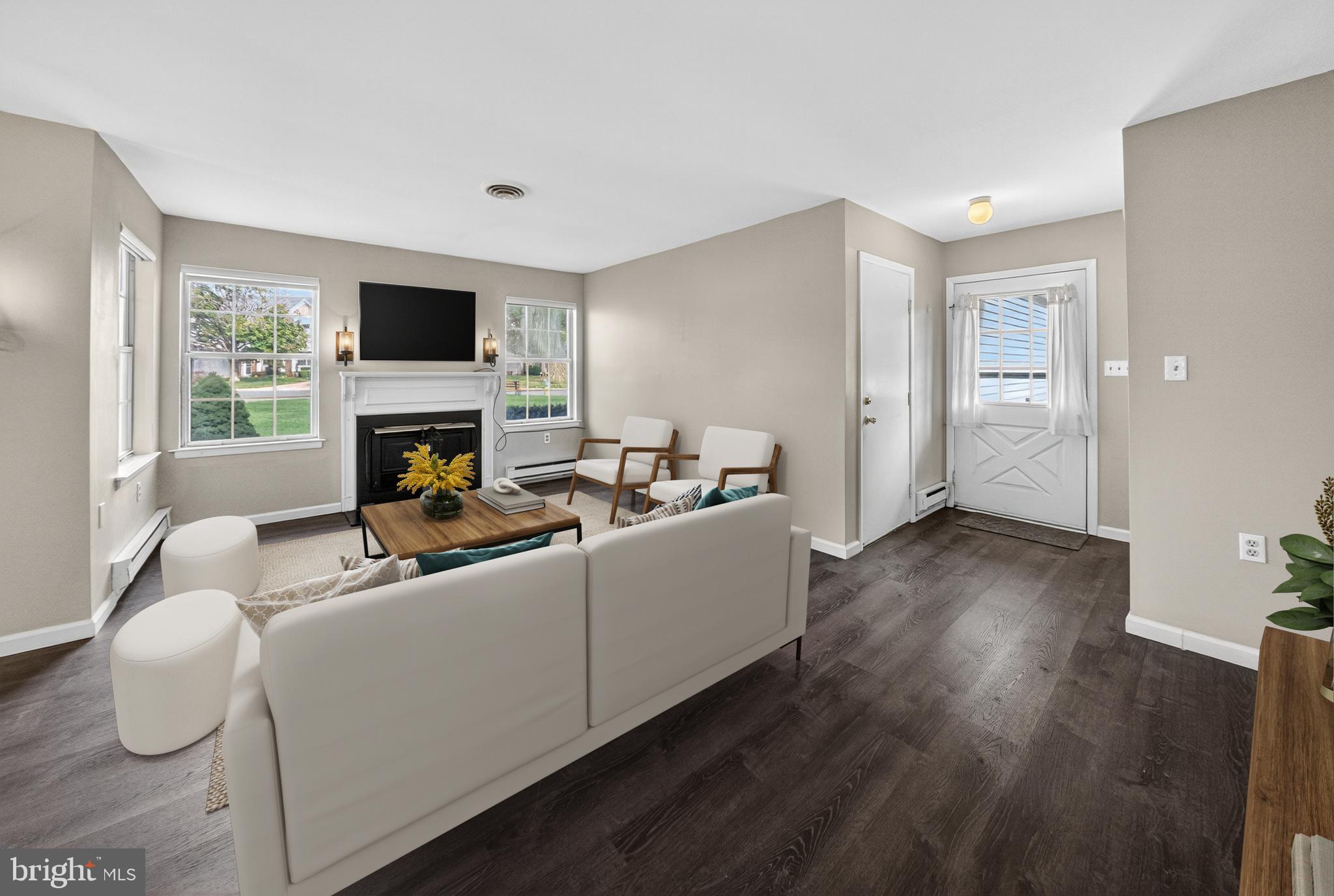 7043 Basswood Road Frederick, MD 21703 - Photo 6 of 34 a living room with furniture a flat screen tv and a fireplace