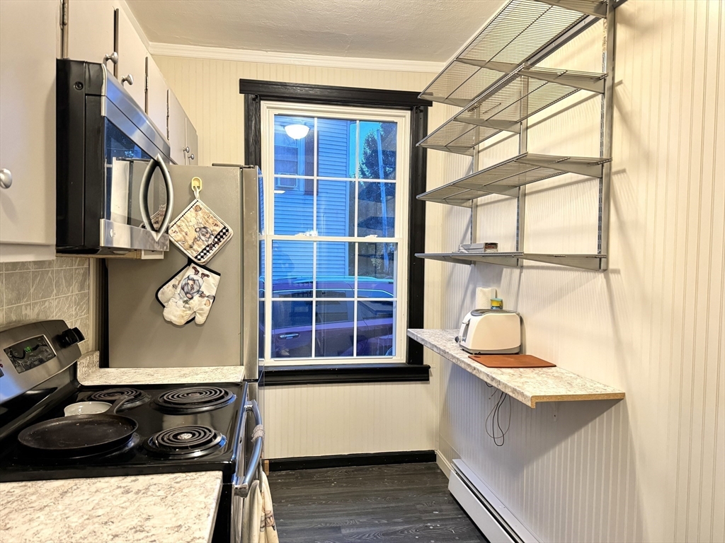 4 Foster Street Rochdale, MA 01542 - Photo 12 of 28 a kitchen with a sink and a stove next to a window