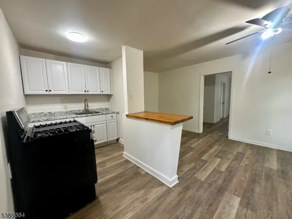 a kitchen with a sink and a stove top oven