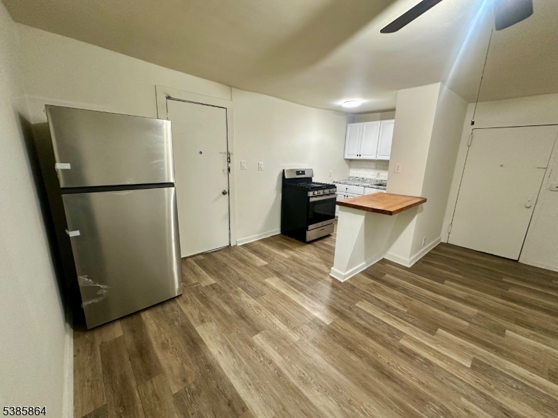 390 Orange Road, Unit 2 Montclair, NJ 07042 - Photo 4 of 16 a kitchen with a refrigerator and a sink
