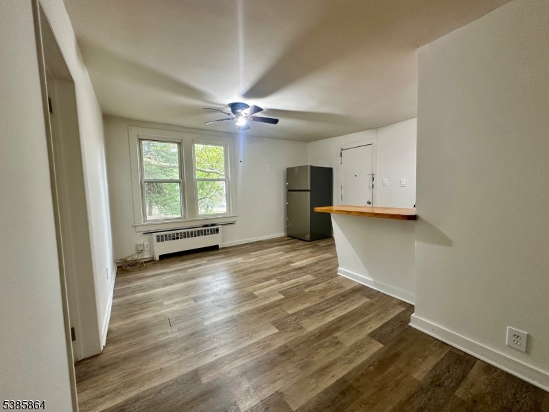 390 Orange Road, Unit 2 Montclair, NJ 07042 - Photo 6 of 16 wooden floor in an empty room with a window