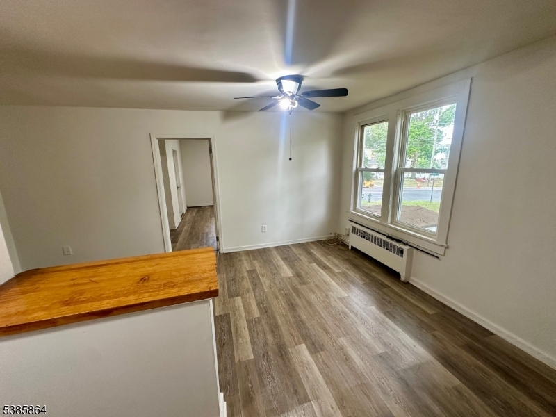 390 Orange Road, Unit 2 Montclair, NJ 07042 - Photo 8 of 16 a view of a room with wooden floor and fan