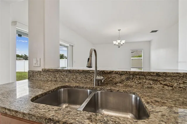 a kitchen with sink and bathtub