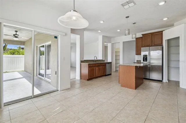 a kitchen with stainless steel appliances granite countertop a refrigerator and a sink