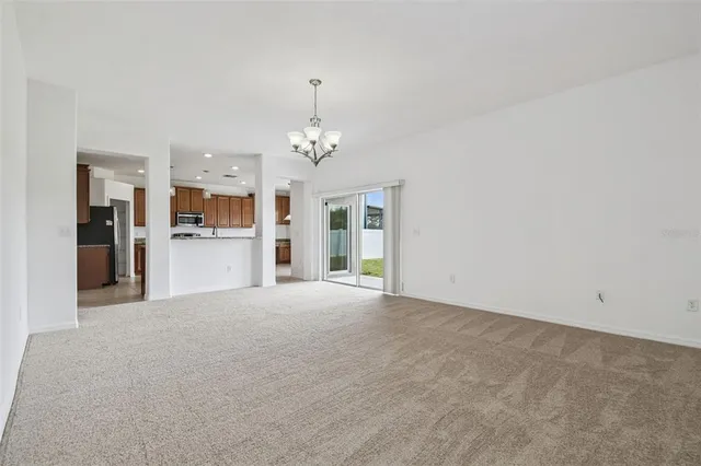 a view of a kitchen with a sink and a refrigerator