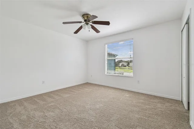 a view of room with window and ceiling fan