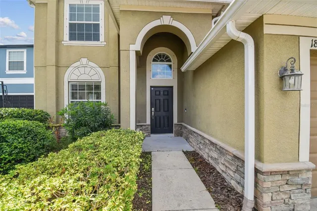 a view of a brick house with large windows