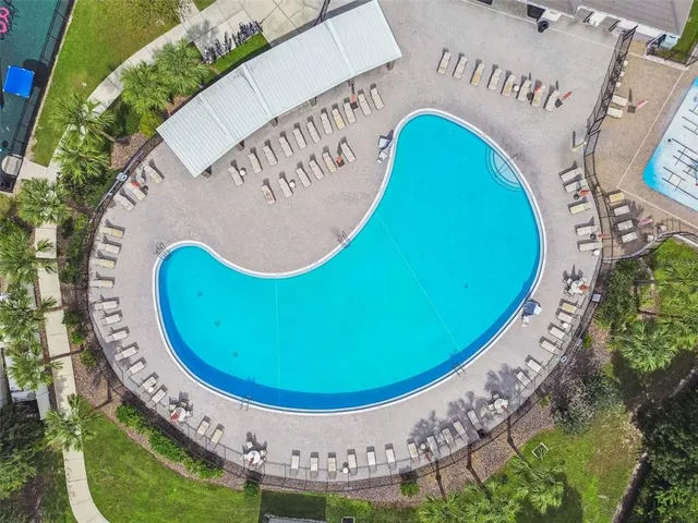 an aerial view of a house with a swimming pool yard and outdoor seating