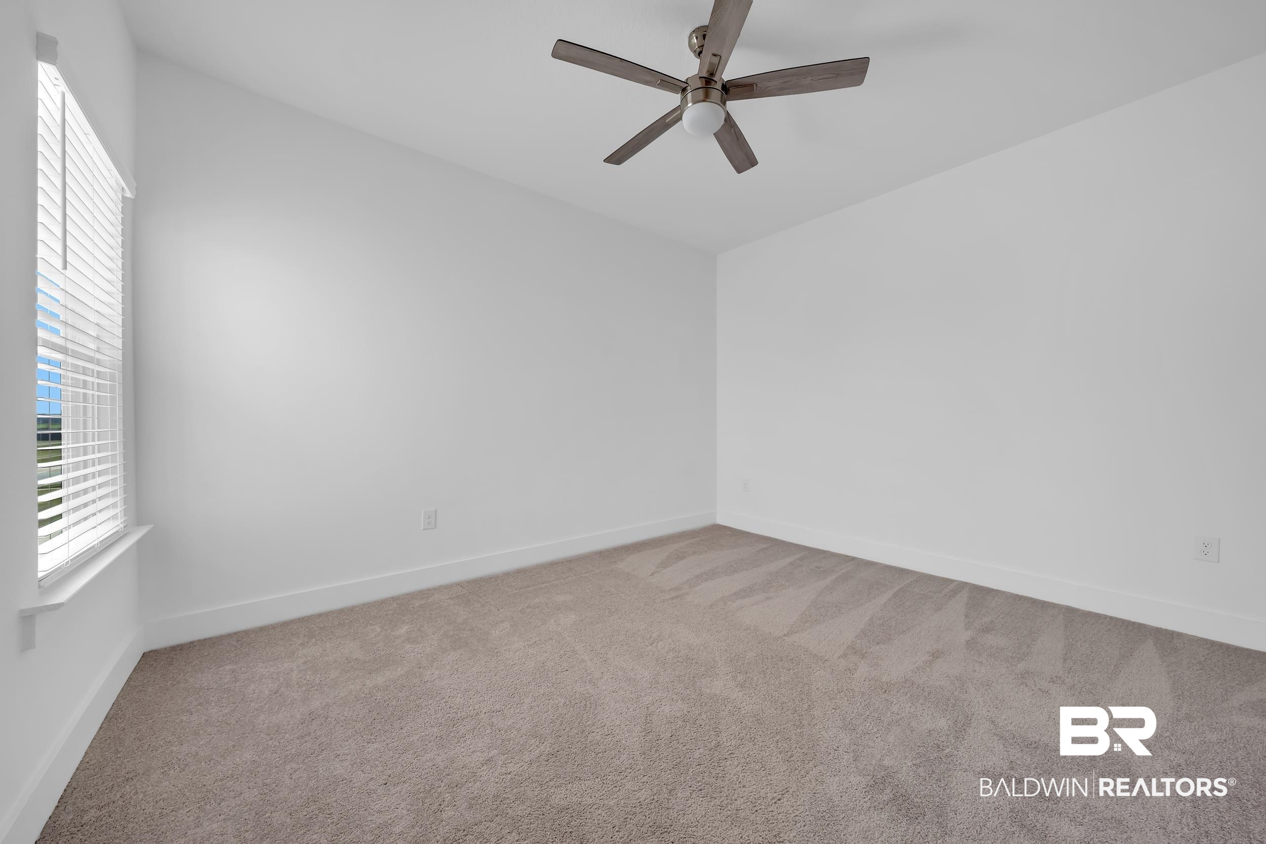9933 Weller Cove Foley, AL 36535 - Photo 25 of 36 Neutral carpeted room featuring a ceiling fan with integrated lighting, white walls, and a window with horizontal blinds