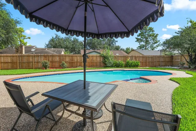 a view of a table and chairs under an umbrella