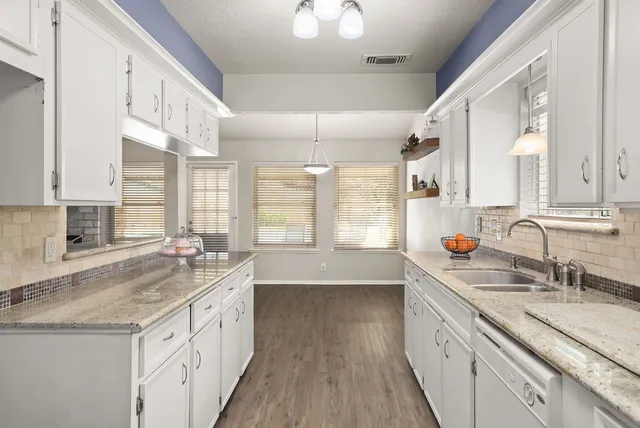a kitchen with a sink stove and cabinets