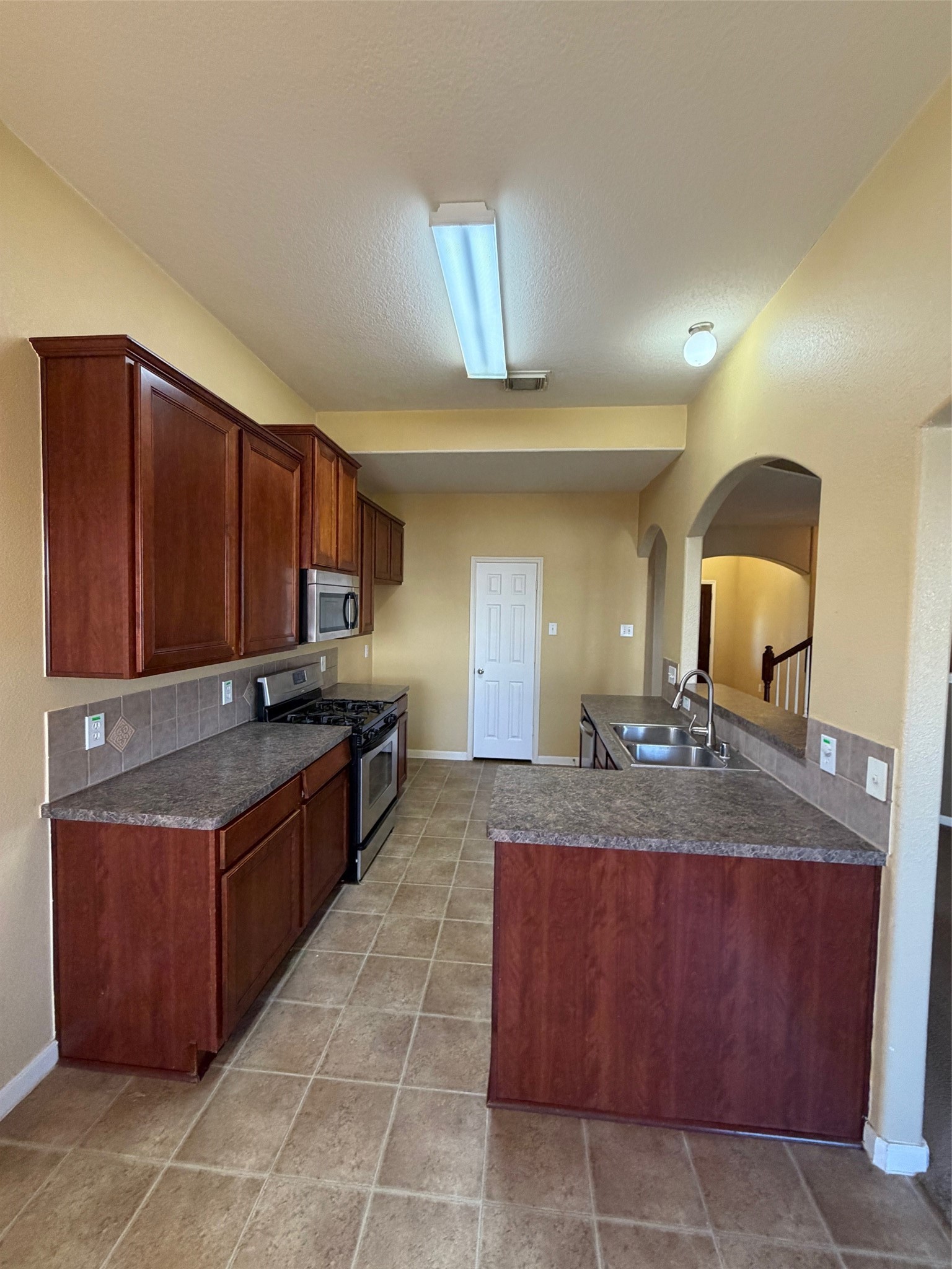 25214 Spring Iris Lane Katy, TX 77494 - Photo 11 of 23 a large kitchen with kitchen island granite countertop a large counter top and wooden cabinets
