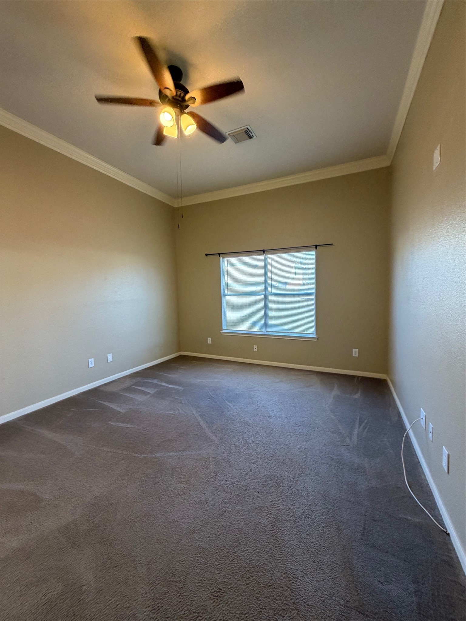 25214 Spring Iris Lane Katy, TX 77494 - Photo 15 of 23 an empty room with a ceiling fan and window