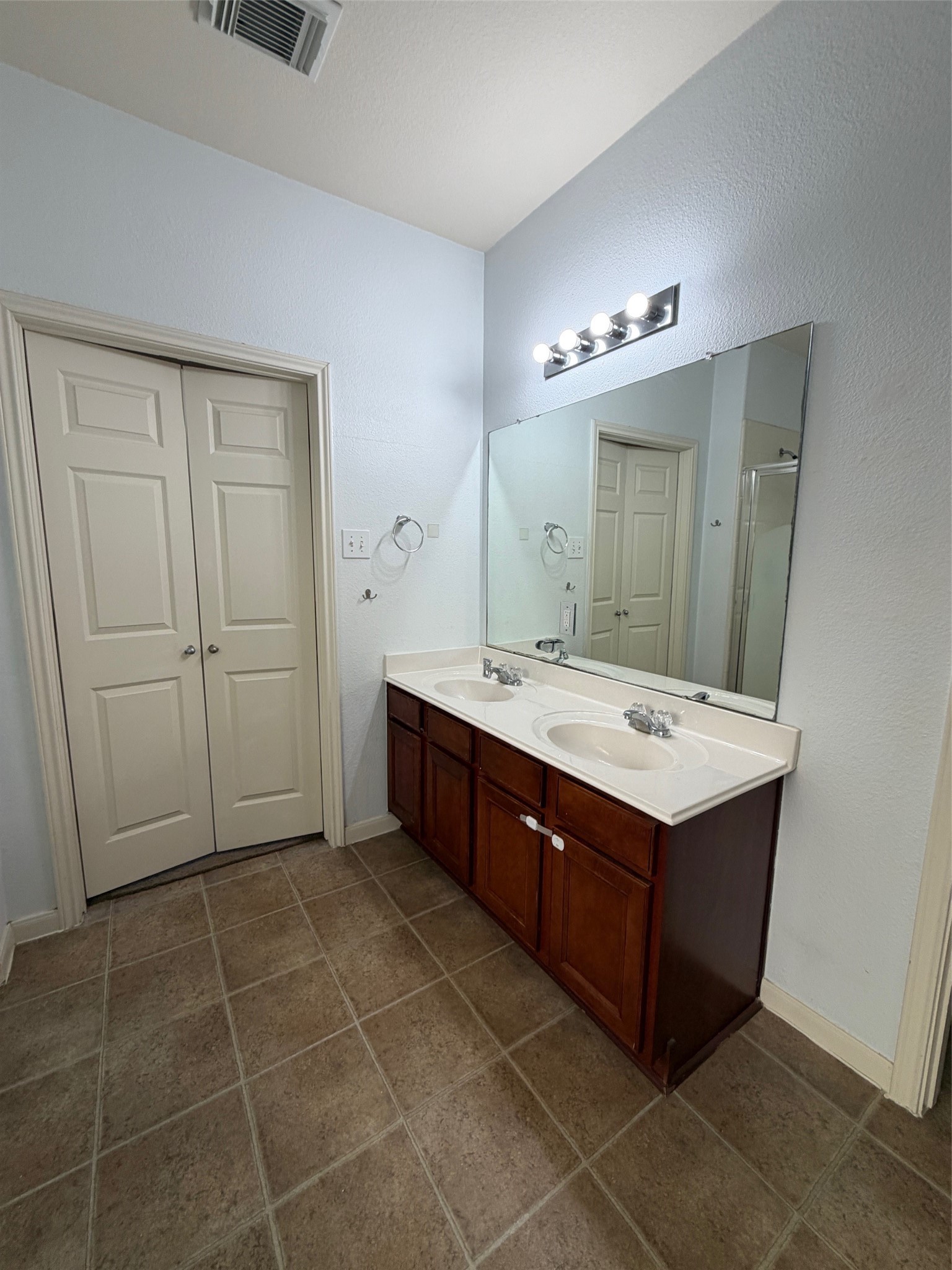 25214 Spring Iris Lane Katy, TX 77494 - Photo 19 of 23 a bathroom with a double vanity sink and a mirror