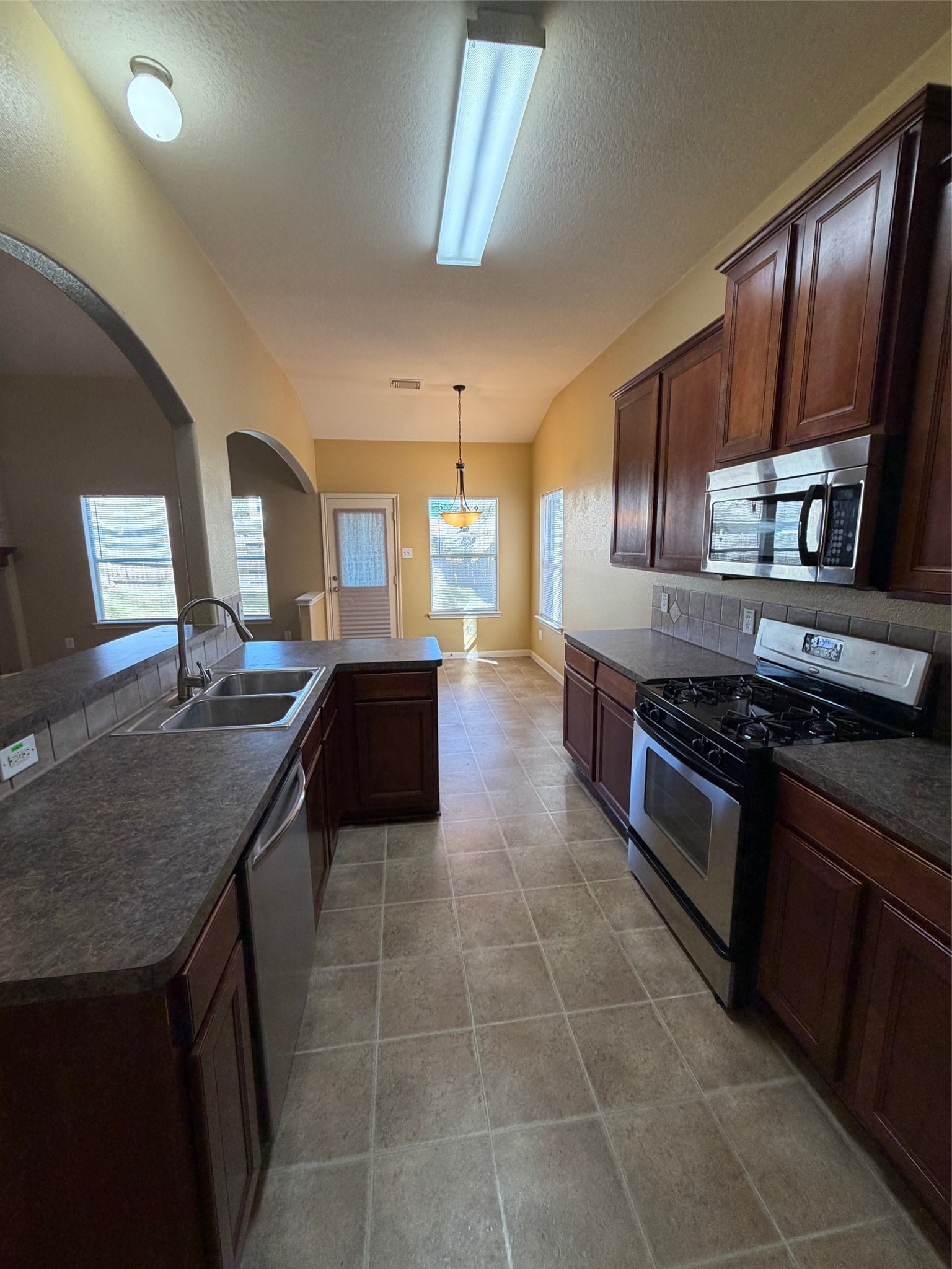 25214 Spring Iris Lane Katy, TX 77494 - Photo 9 of 23 a kitchen with stainless steel appliances granite countertop a stove a sink dishwasher and a refrigerator