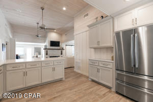 13007 Oleander Drive Panama City Beach, FL 32407 - Photo 5 of 7 a kitchen with kitchen island a sink stainless steel appliances and cabinets