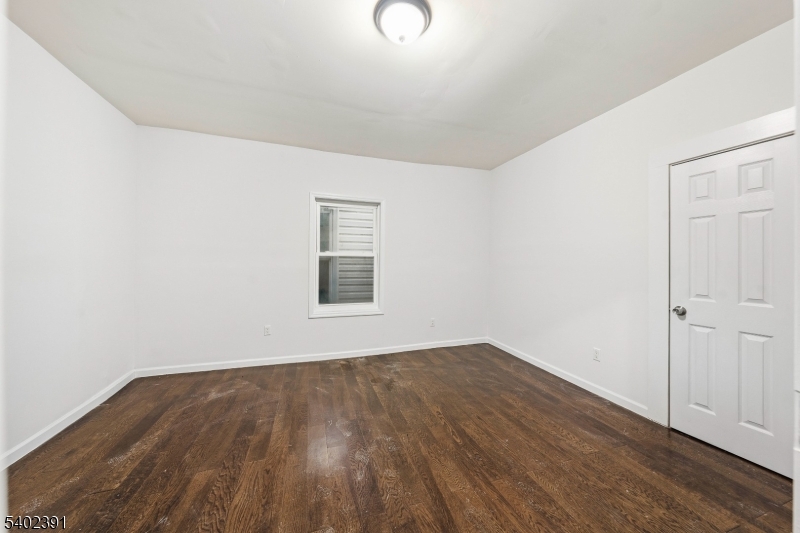 152 South 10th Street Newark, NJ 07107 - Photo 13 of 21 an empty room with wooden floor and windows