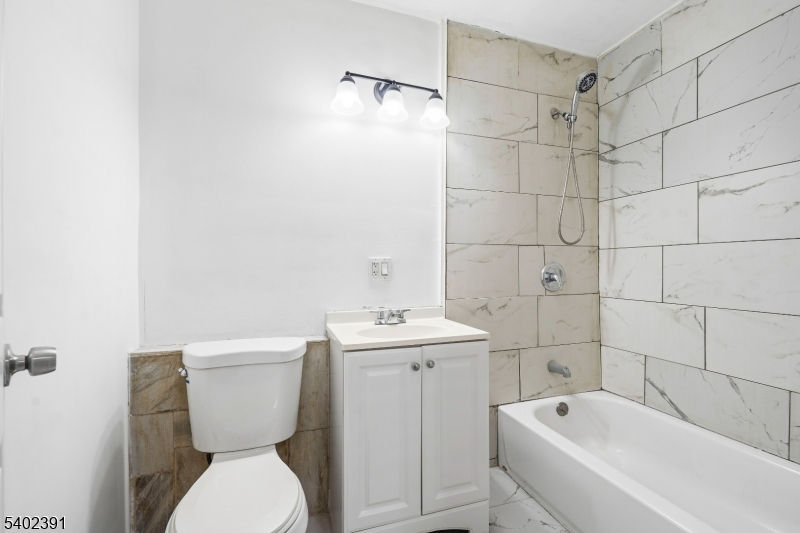 152 South 10th Street Newark, NJ 07107 - Photo 9 of 21 a bathroom with a toilet sink and shower